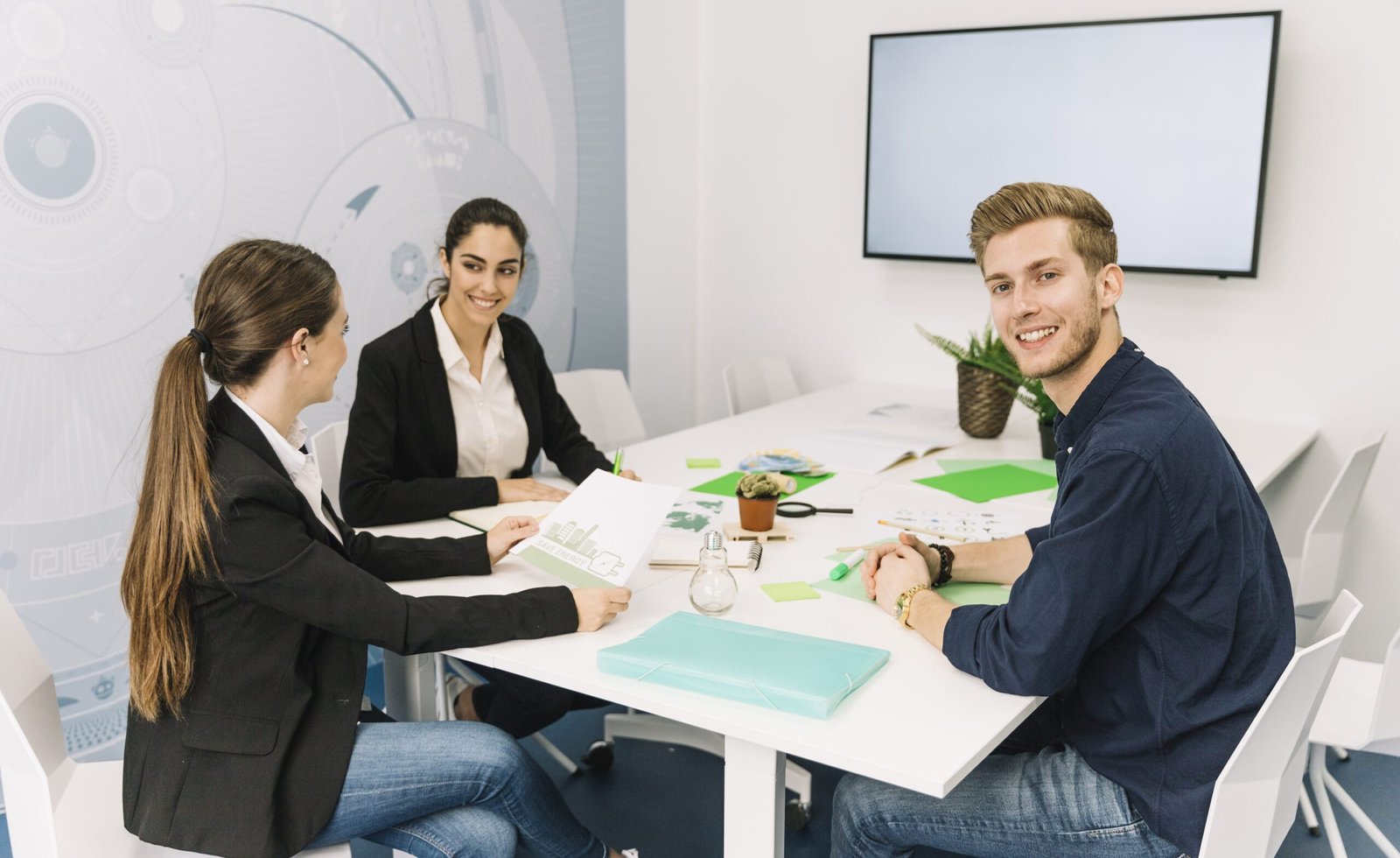 group-smiling-young-businesspeople-workplace